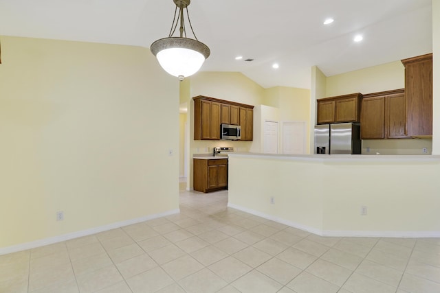 kitchen with pendant lighting, brown cabinets, stainless steel appliances, lofted ceiling, and light countertops