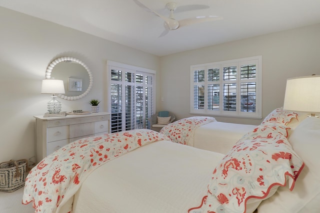 bedroom featuring multiple windows and ceiling fan