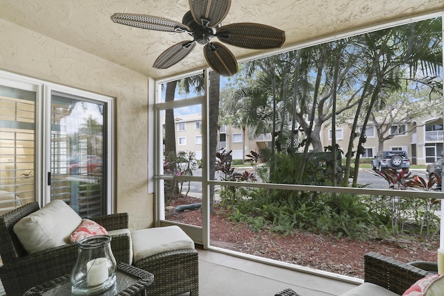 sunroom featuring a ceiling fan