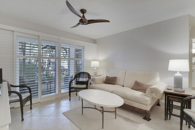 living area featuring light tile patterned floors and ceiling fan