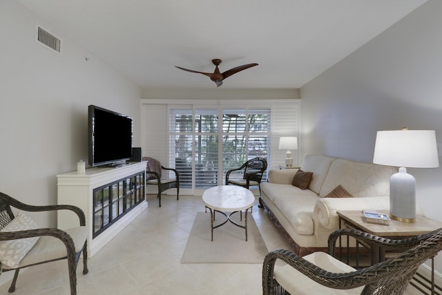 living room featuring light tile patterned floors, visible vents, and ceiling fan