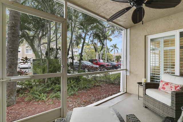 sunroom featuring a ceiling fan