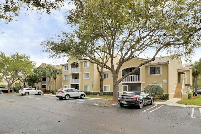 view of property with a residential view and uncovered parking