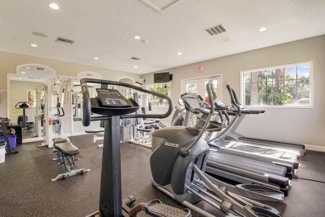 workout area featuring recessed lighting, baseboards, visible vents, and a textured ceiling