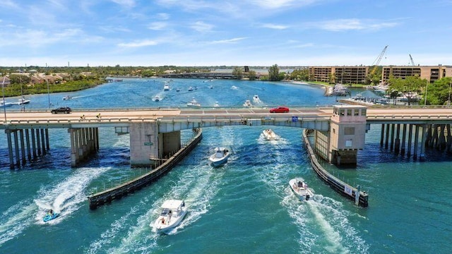 view of swimming pool with a pier and a water view