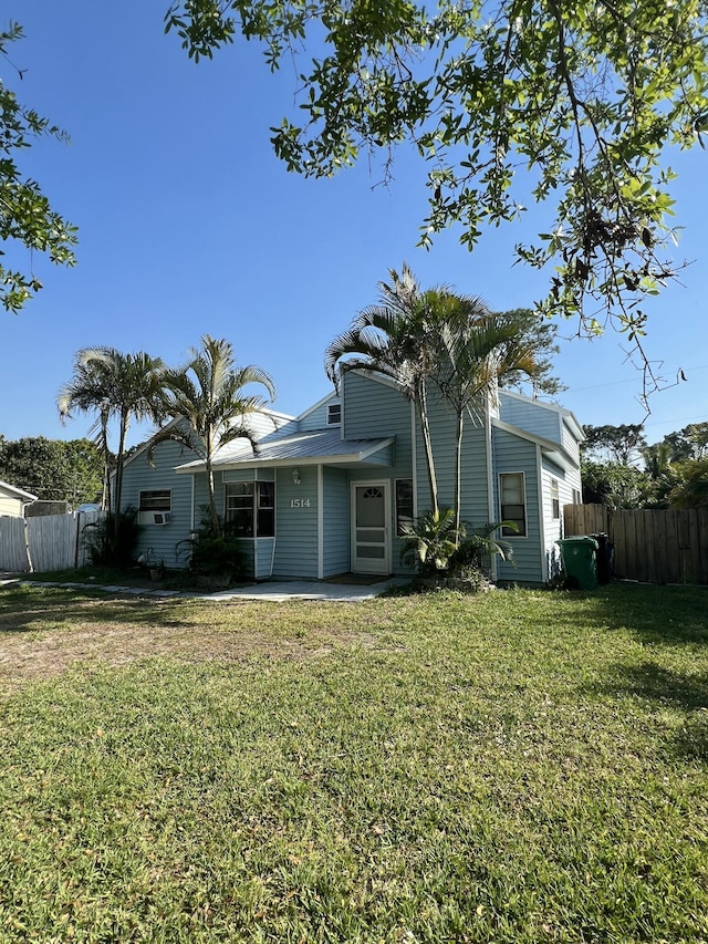 back of property featuring fence, a patio, and a yard