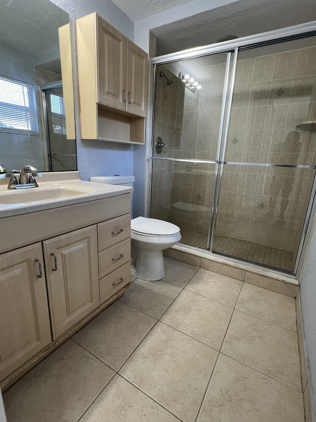 full bathroom with toilet, a stall shower, tile patterned flooring, and vanity