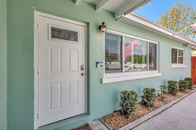 entrance to property with stucco siding