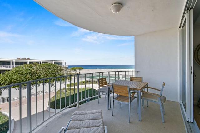 balcony with a water view and a beach view