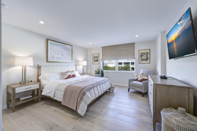 bedroom with baseboards, light wood finished floors, and recessed lighting