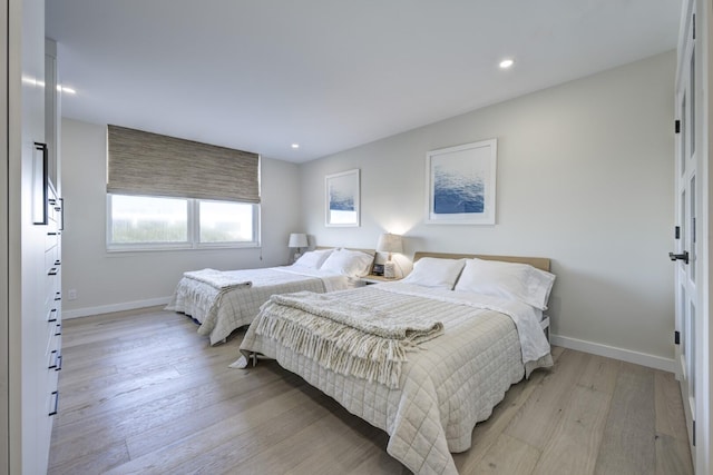 bedroom featuring recessed lighting, light wood-type flooring, and baseboards