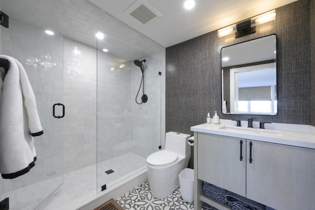 full bath with toilet, a stall shower, visible vents, and vanity