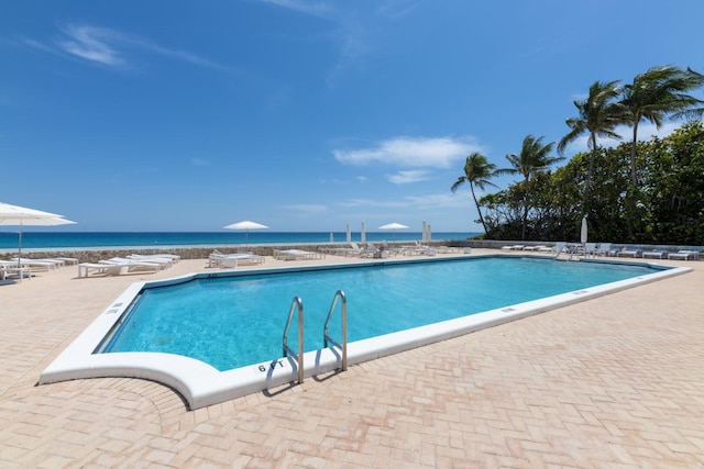 pool with a water view and a patio