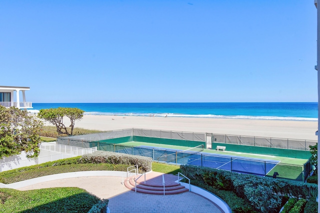 water view featuring a beach view and fence