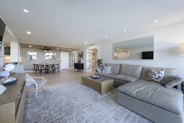 living area with recessed lighting, visible vents, ceiling fan, and wood finished floors