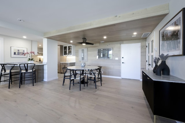 dining area with light wood finished floors and recessed lighting