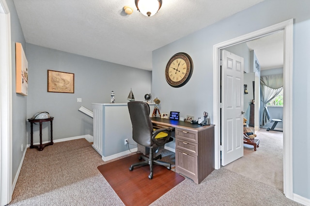 office space featuring light carpet and baseboards