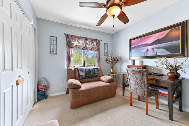 home office with light carpet, baseboards, and a ceiling fan