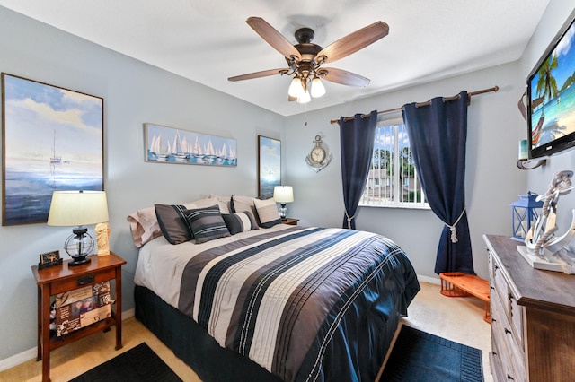 carpeted bedroom featuring baseboards and a ceiling fan