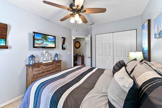 carpeted bedroom with baseboards, ceiling fan, visible vents, and a closet