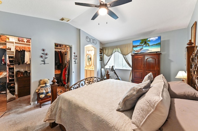 bedroom featuring visible vents, arched walkways, lofted ceiling, ceiling fan, and carpet flooring