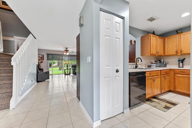 kitchen featuring light tile patterned flooring, a sink, visible vents, light countertops, and dishwasher