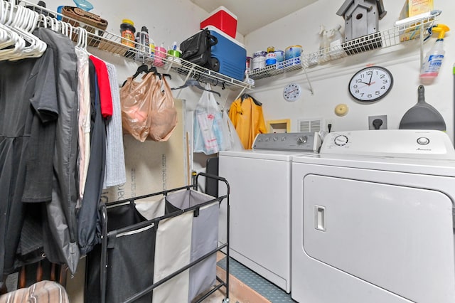 clothes washing area with laundry area and washer and clothes dryer