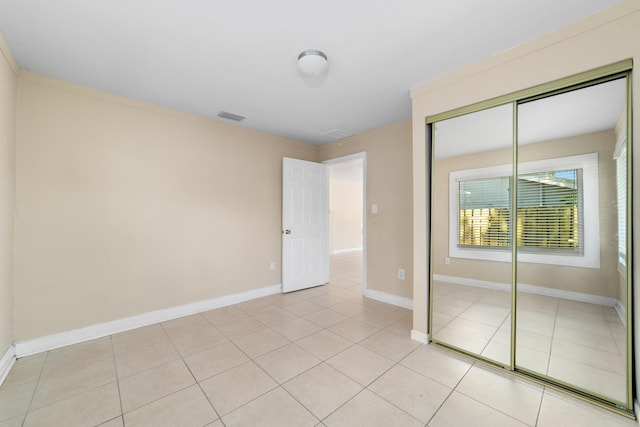 1204 Easter Ave, Fort Pierce, FL 34950 - unfurnished bedroom featuring light tile patterned floors, a closet, and baseboards