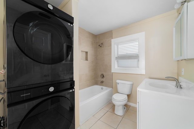 1204 Easter Ave, Fort Pierce, FL 34950 - full bathroom featuring stacked washer / dryer, toilet, vanity, shower / bathtub combination, and tile patterned floors