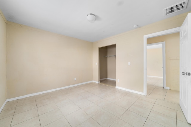 1204 Easter Ave, Fort Pierce, FL 34950 - unfurnished bedroom with light tile patterned floors, baseboards, and a closet