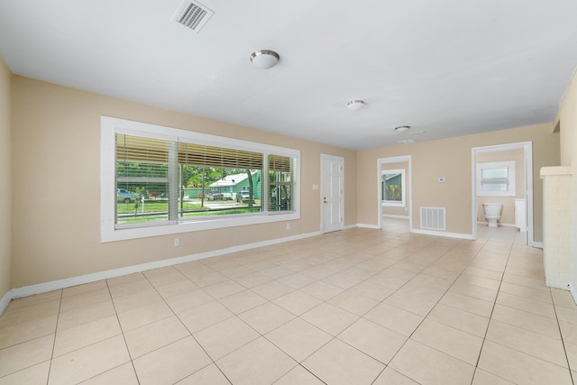 1204 Easter Ave, Fort Pierce, FL 34950 - spare room with healthy amount of natural light, baseboards, and light tile patterned floors