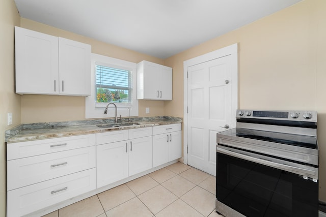 1204 Easter Ave, Fort Pierce, FL 34950 - kitchen with stainless steel electric range oven, a sink, white cabinetry, and light stone countertops
