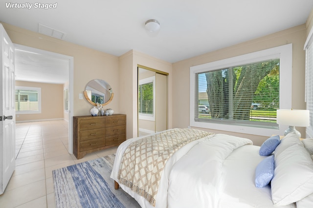 1204 Easter Ave, Fort Pierce, FL 34950 - bedroom featuring light tile patterned flooring, a closet, and baseboards