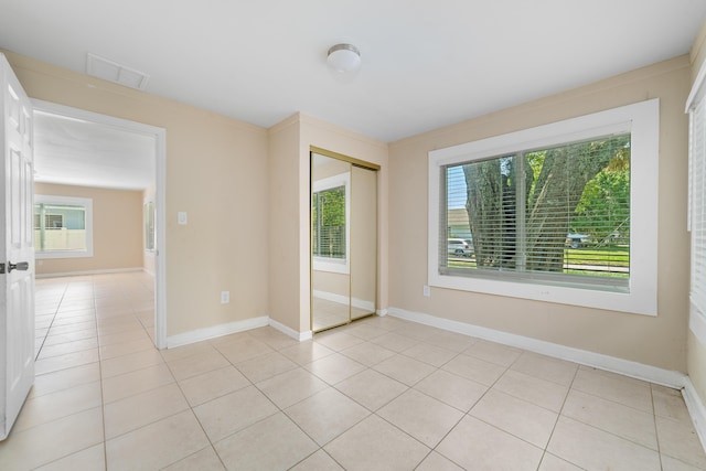 1204 Easter Ave, Fort Pierce, FL 34950 - empty room with light tile patterned flooring and baseboards
