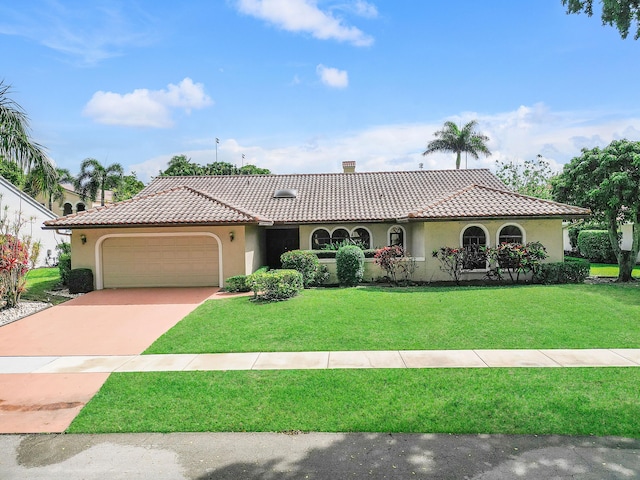 mediterranean / spanish-style home featuring a garage, a tile roof, concrete driveway, stucco siding, and a front yard