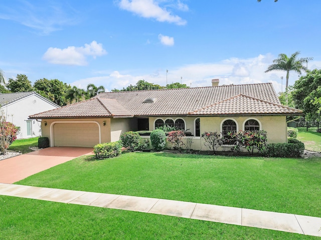 view of front facade with a garage, a tile roof, a front lawn, and stucco siding