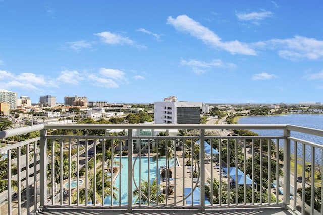 balcony featuring a city view and a water view