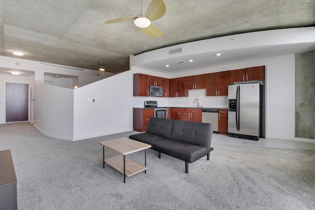 living room with light carpet, ceiling fan, visible vents, and baseboards