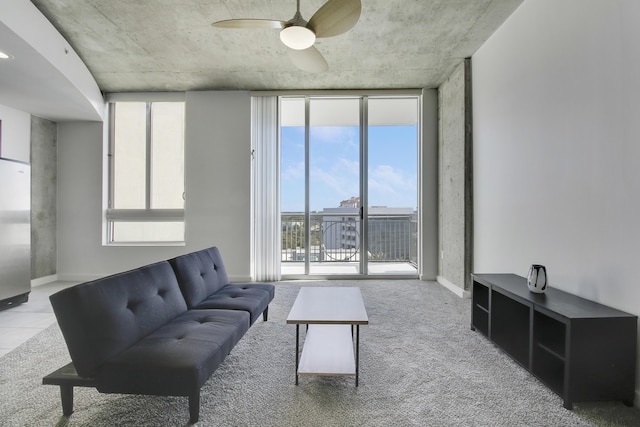 living room with expansive windows, baseboards, and a ceiling fan