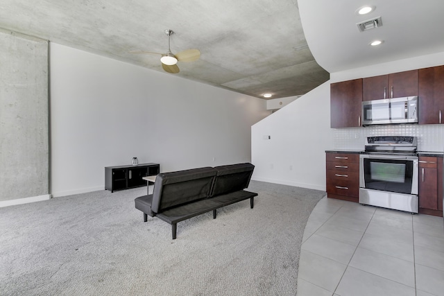 kitchen with light colored carpet, visible vents, baseboards, appliances with stainless steel finishes, and backsplash