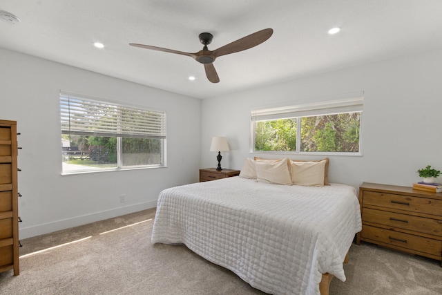 carpeted bedroom featuring ceiling fan, baseboards, and recessed lighting