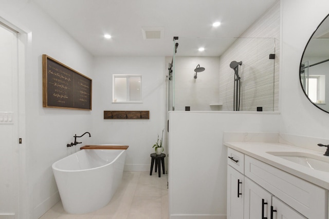 bathroom with visible vents, a tile shower, a freestanding bath, vanity, and recessed lighting