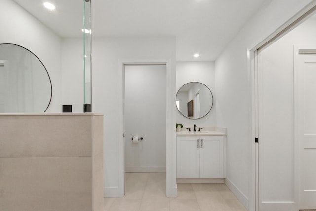 bathroom with recessed lighting, vanity, baseboards, and tile patterned floors