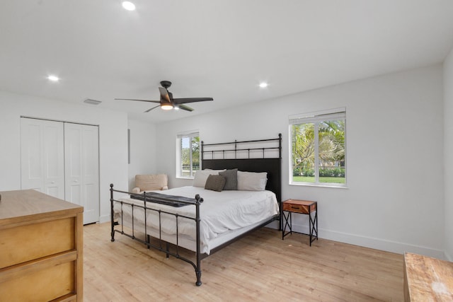 bedroom featuring light wood-style flooring, visible vents, a closet, and recessed lighting