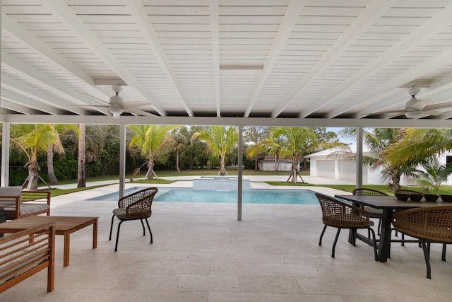 view of pool with ceiling fan, outdoor dining area, a patio area, and an outdoor structure