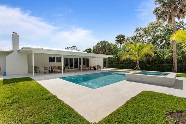 view of swimming pool featuring an in ground hot tub, a yard, a patio, and a fenced in pool