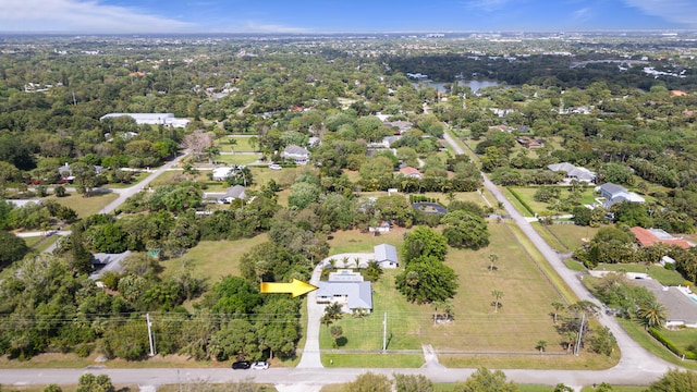 drone / aerial view featuring a wooded view