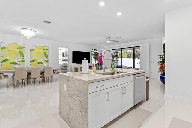 kitchen with a kitchen island with sink, a sink, visible vents, white cabinets, and dishwasher