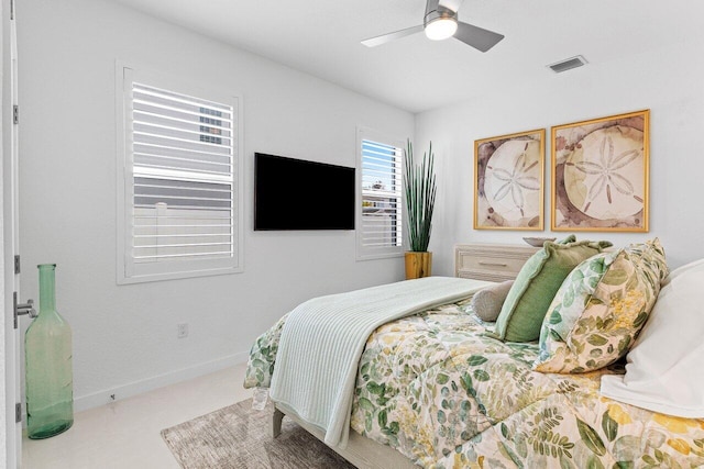 bedroom with baseboards, visible vents, and a ceiling fan