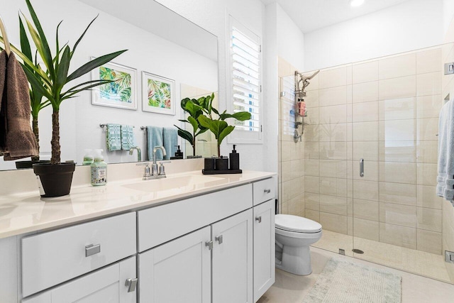 bathroom featuring a stall shower, vanity, toilet, and tile patterned floors